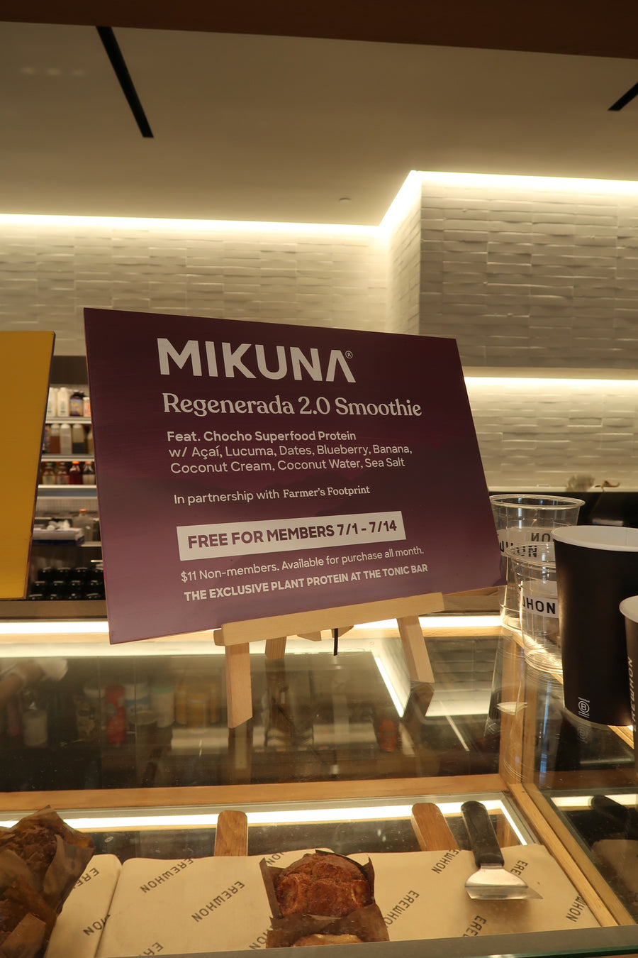 The Regenerada 2.0 smoothie beside its counter card at the Erewhon Tonic Bar