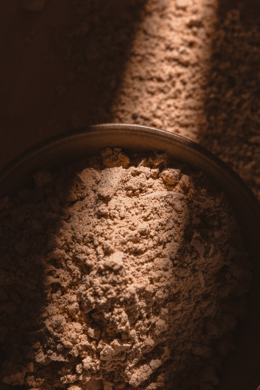 A MIKUNA Chocho Plant Protein bag with a scoop of powder